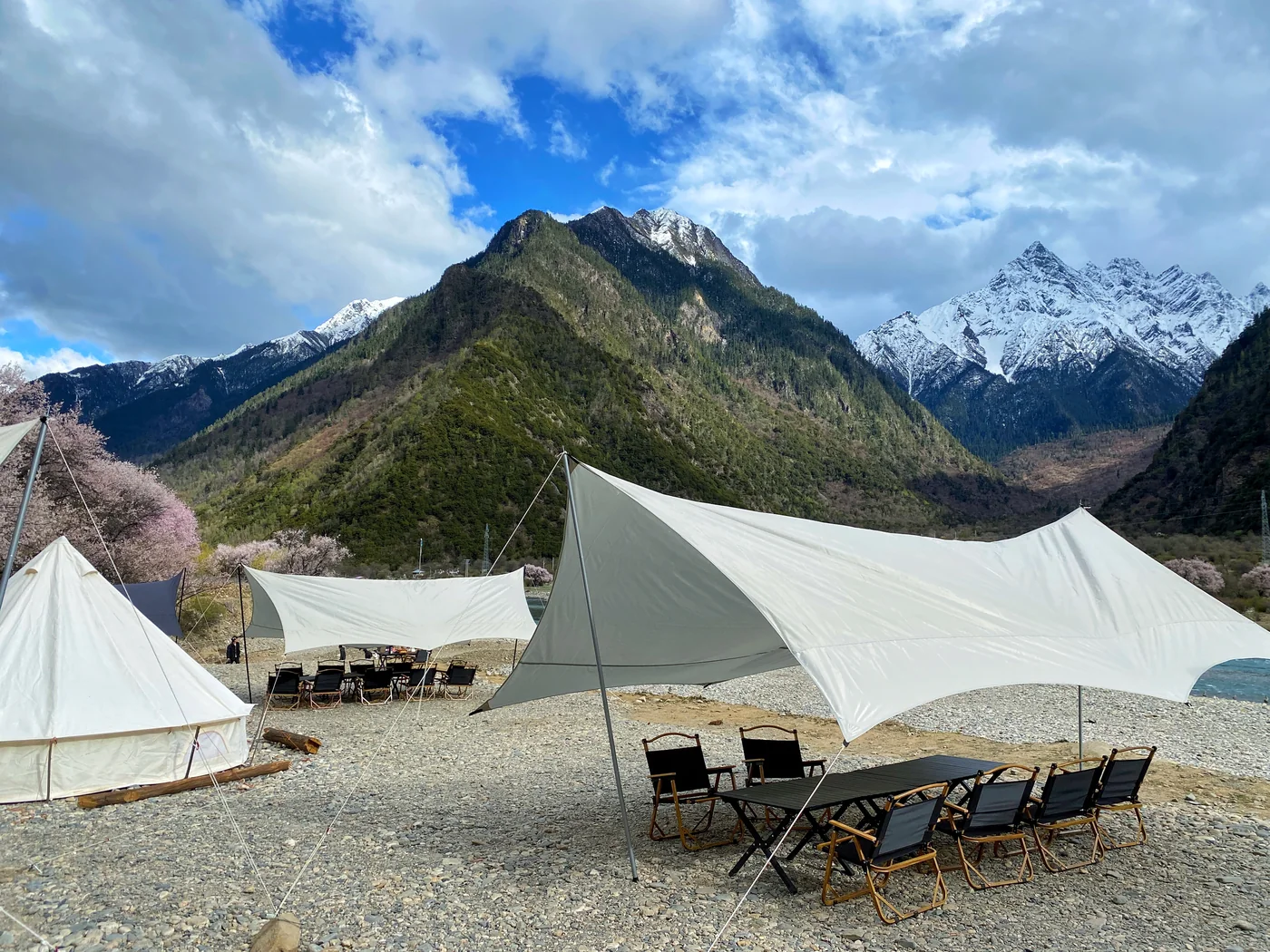 Tented mountain camp beneath snow peaks in Nyingchi, Tibet